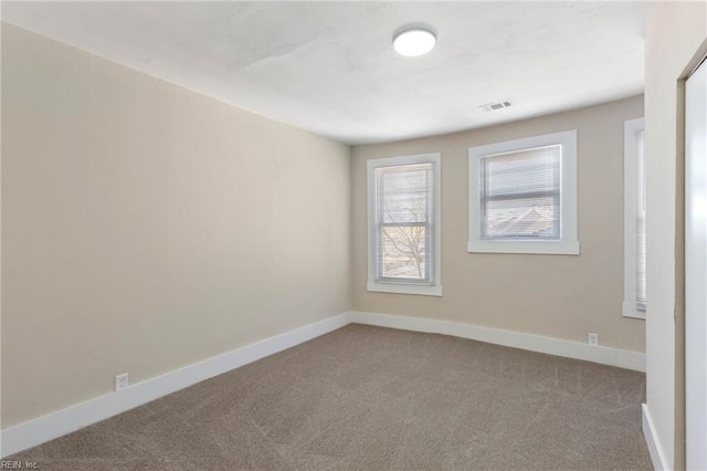 unfurnished room featuring light carpet