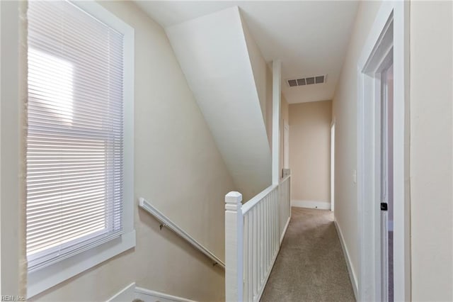 hallway with light colored carpet