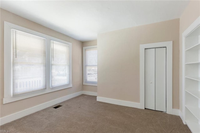 unfurnished room with light carpet