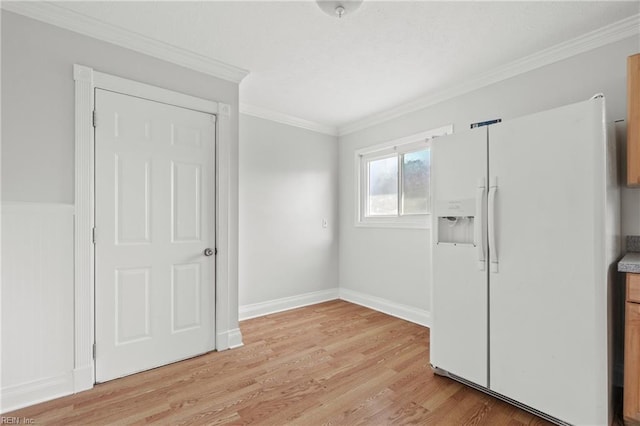 interior space featuring light hardwood / wood-style flooring, ornamental molding, and white fridge with ice dispenser