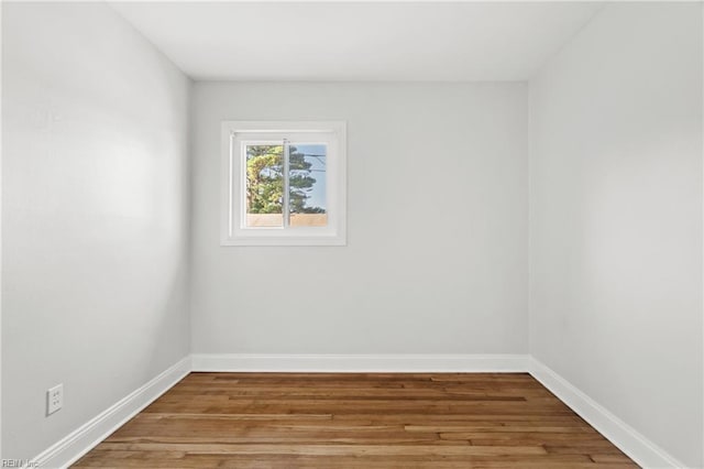 unfurnished room with hardwood / wood-style floors