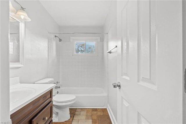 full bathroom with vanity, tiled shower / bath combo, and toilet