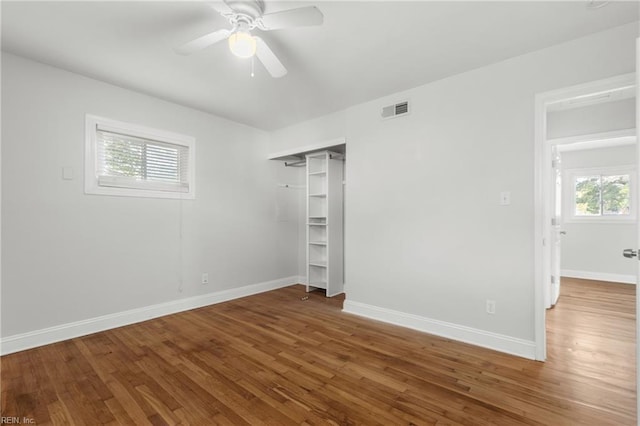 spare room with hardwood / wood-style floors and ceiling fan