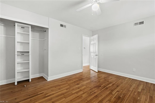 unfurnished bedroom featuring hardwood / wood-style flooring, a closet, and ceiling fan