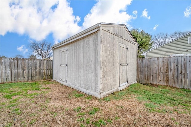 view of outbuilding with a lawn