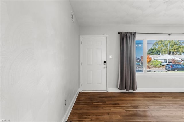 unfurnished room featuring dark hardwood / wood-style flooring