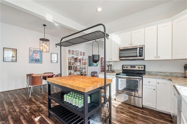 kitchen with dark hardwood / wood-style flooring, decorative light fixtures, white cabinets, and appliances with stainless steel finishes