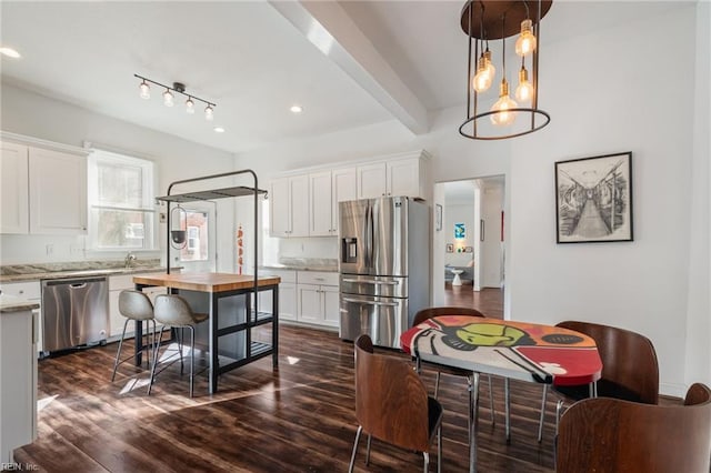 kitchen featuring stainless steel appliances, light stone countertops, white cabinets, and dark hardwood / wood-style flooring