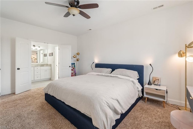 bedroom featuring connected bathroom, ceiling fan, and carpet