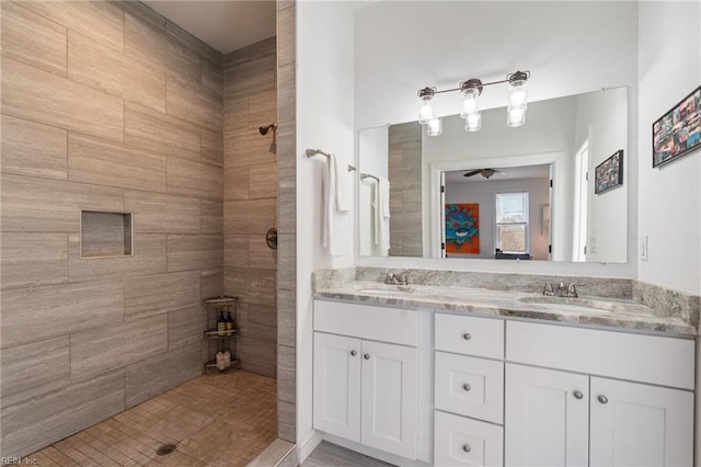 bathroom featuring vanity, a tile shower, and ceiling fan