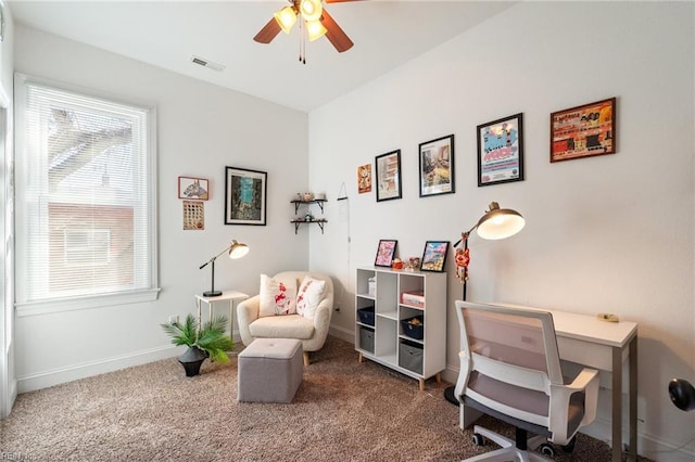 sitting room featuring ceiling fan and carpet