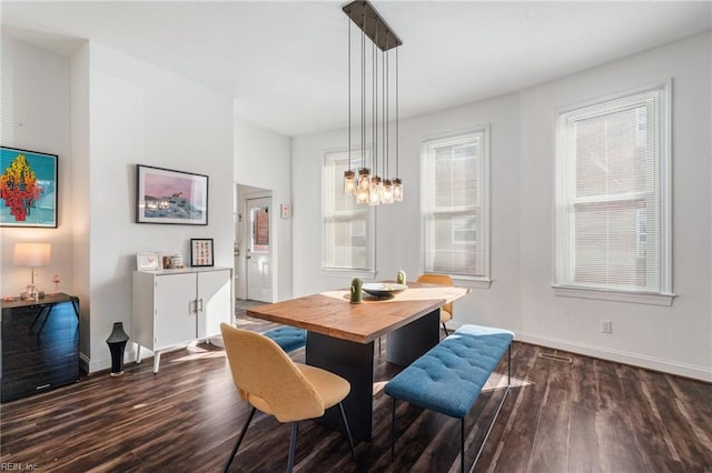 dining area featuring an inviting chandelier and dark hardwood / wood-style floors