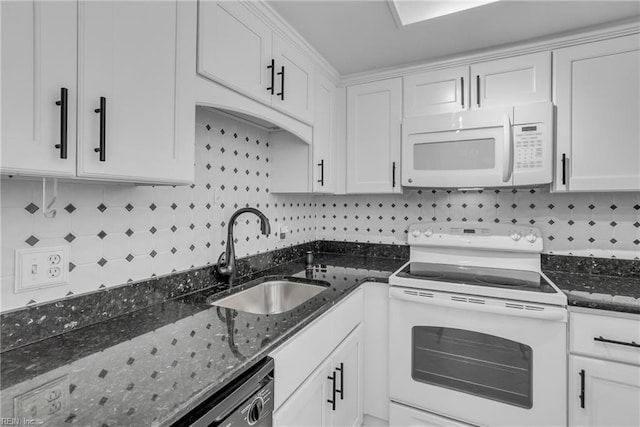 kitchen featuring white cabinetry, white appliances, dark stone counters, and sink