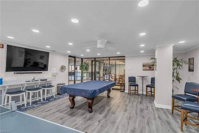 game room with pool table, ornamental molding, ceiling fan, and light wood-type flooring