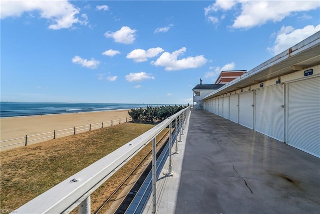 balcony featuring a view of the beach and a water view