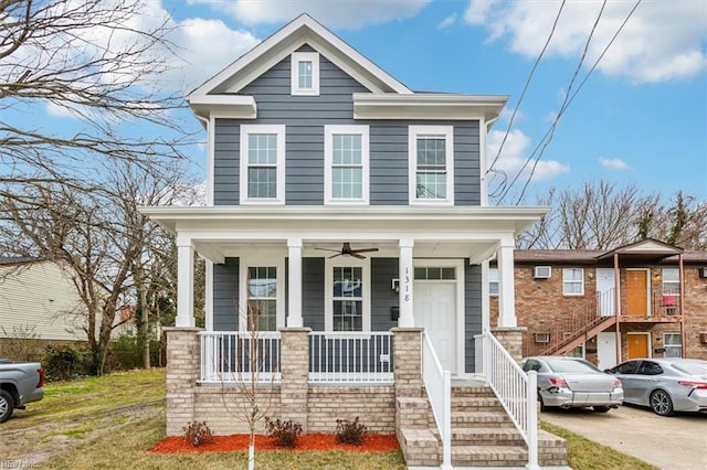 view of front of house with a porch and a front yard