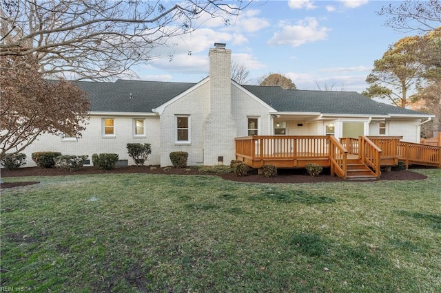 rear view of property with a yard and a deck