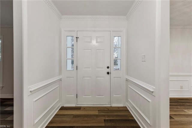 foyer featuring dark wood-type flooring and ornamental molding