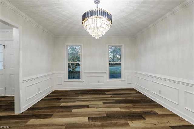 unfurnished dining area with a notable chandelier, dark wood-type flooring, and ornamental molding