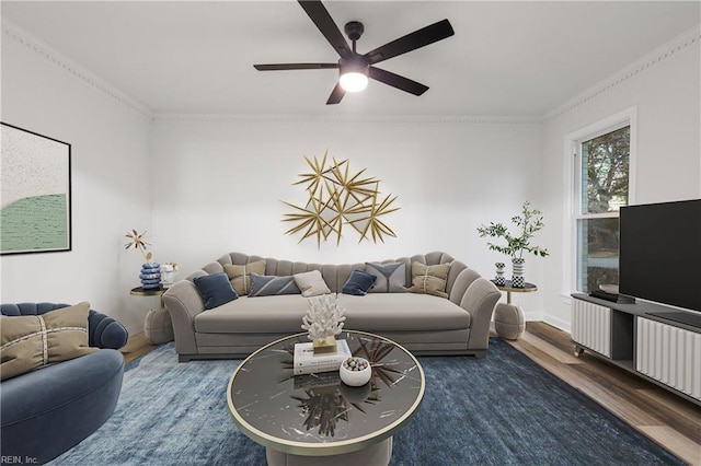 living room featuring crown molding, dark wood-type flooring, and ceiling fan