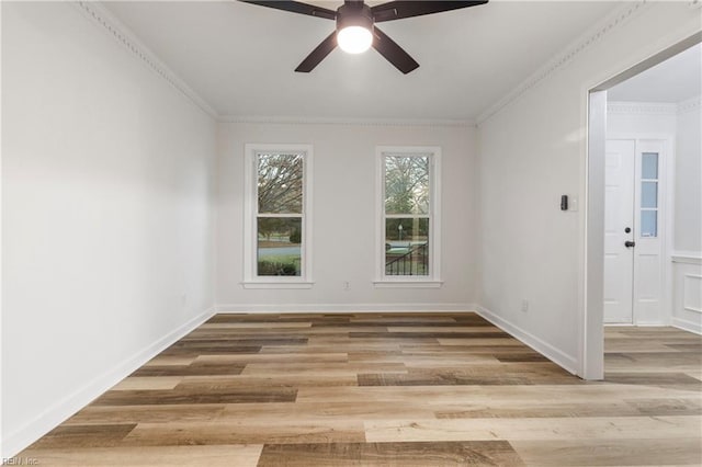 empty room with ceiling fan, ornamental molding, and wood-type flooring