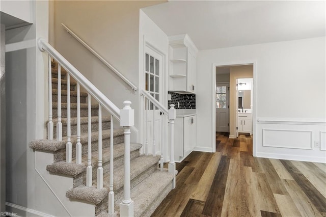 stairs with hardwood / wood-style flooring