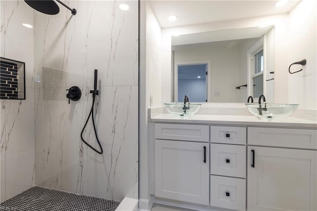 bathroom featuring vanity and tiled shower