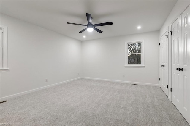 empty room with light colored carpet and ceiling fan