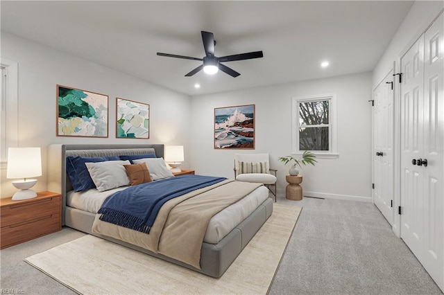 bedroom featuring light colored carpet and ceiling fan