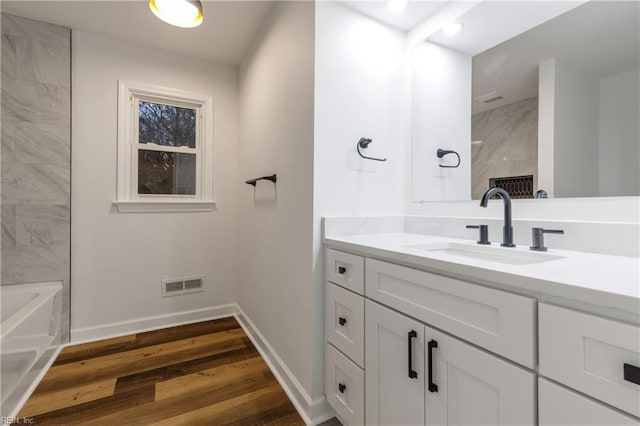 bathroom with vanity and hardwood / wood-style floors