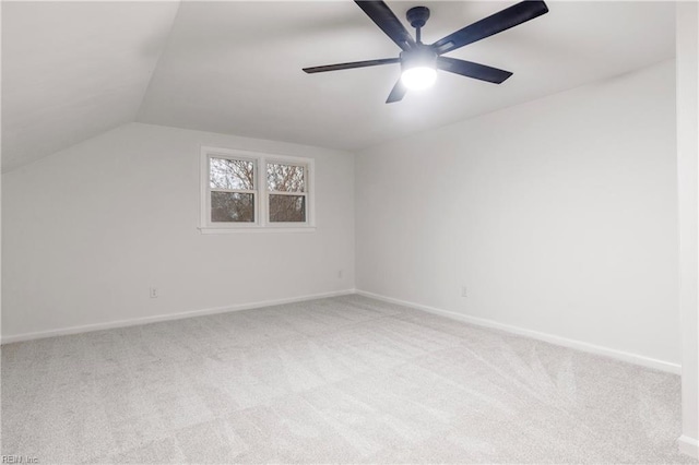 additional living space featuring lofted ceiling, light colored carpet, and ceiling fan