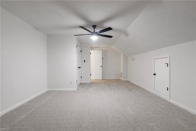 additional living space with light carpet, lofted ceiling, and ceiling fan