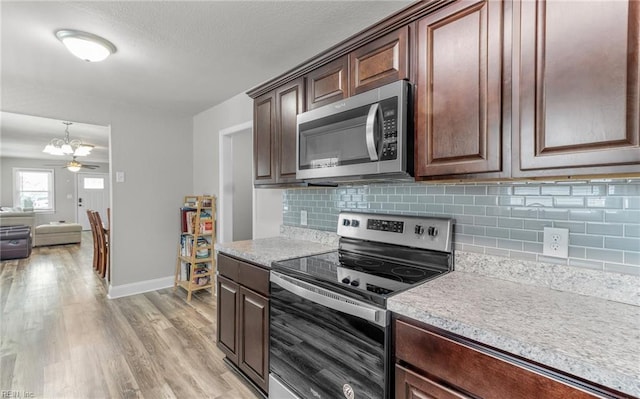 kitchen with ceiling fan, backsplash, stainless steel appliances, dark brown cabinetry, and light hardwood / wood-style floors