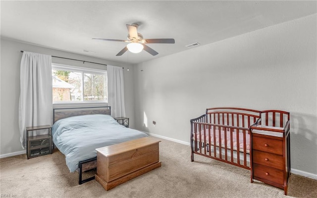 bedroom featuring light colored carpet and ceiling fan