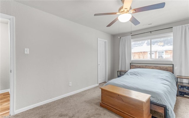 bedroom featuring ceiling fan and light carpet