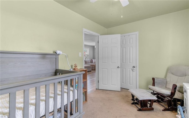 bedroom featuring light colored carpet and ceiling fan