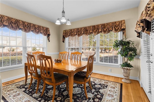 dining area with wood-type flooring