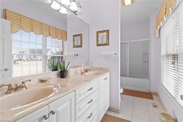 full bathroom featuring tile patterned floors, toilet, an inviting chandelier, bath / shower combo with glass door, and vanity