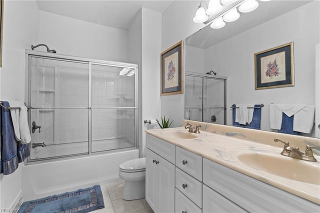 full bathroom featuring enclosed tub / shower combo, vanity, toilet, and tile patterned flooring