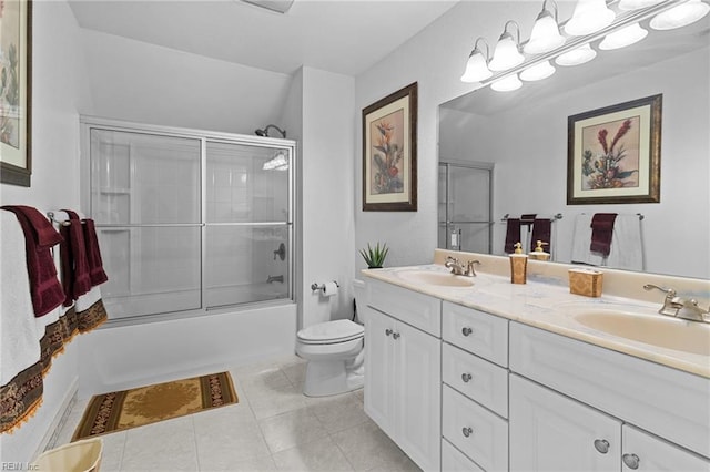 full bathroom with tile patterned flooring, vanity, shower / bath combination with glass door, and toilet