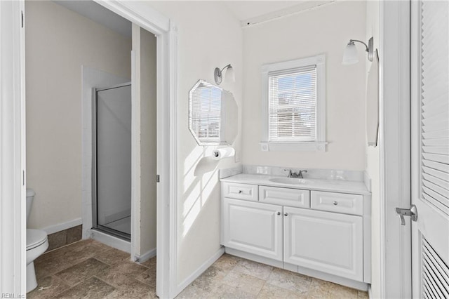 bathroom with vanity, toilet, and a shower with shower door