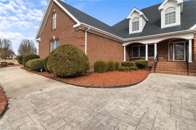 view of side of home featuring a porch