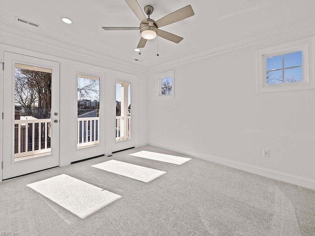 unfurnished room featuring crown molding, light colored carpet, and ceiling fan