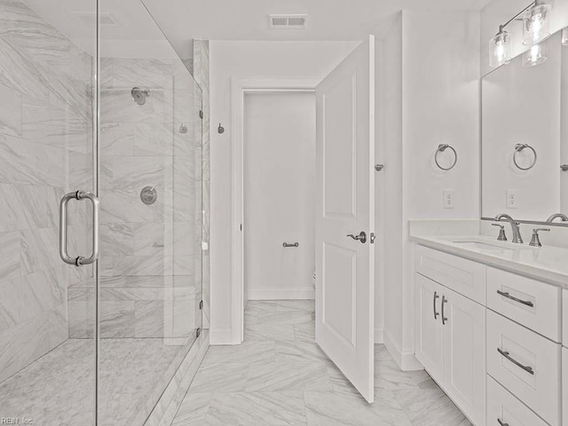 bathroom featuring vanity and a shower with door