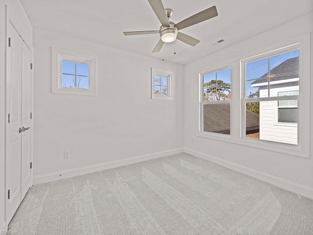 carpeted empty room with ceiling fan