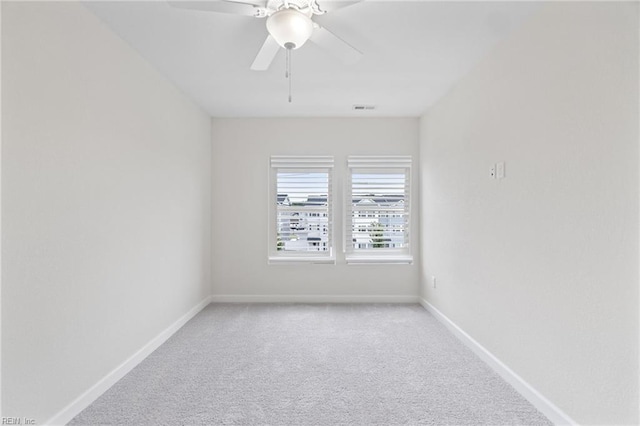 carpeted spare room with ceiling fan