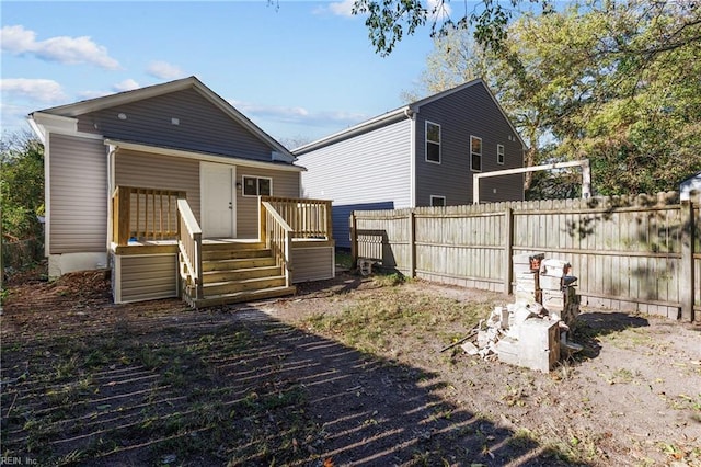 back of property featuring a wooden deck