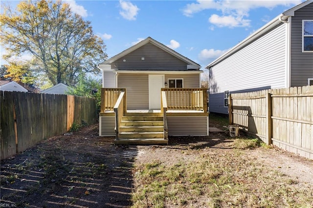 rear view of property with a wooden deck