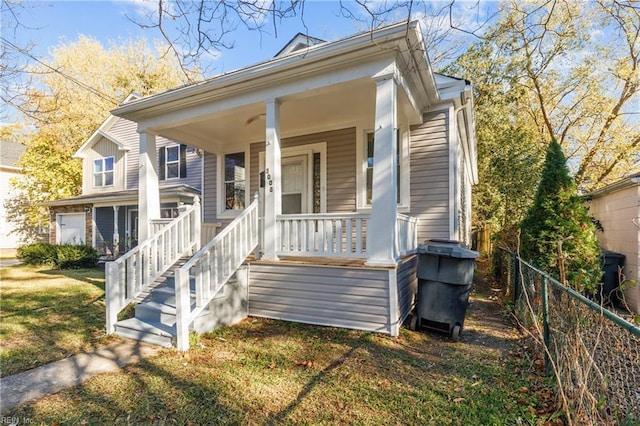 view of front of home with a porch and a front yard