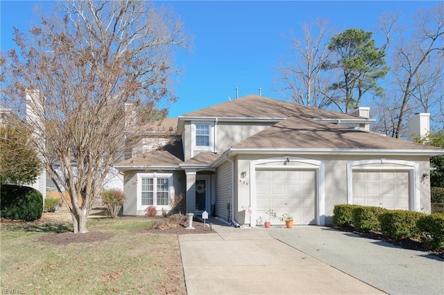 view of property with a garage and a front yard